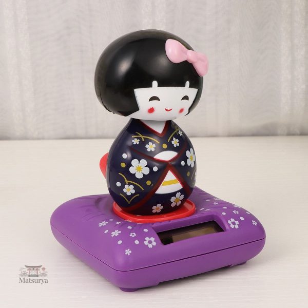 Kokeshi solaire, figurine traditionnelle japonaise en mouvement